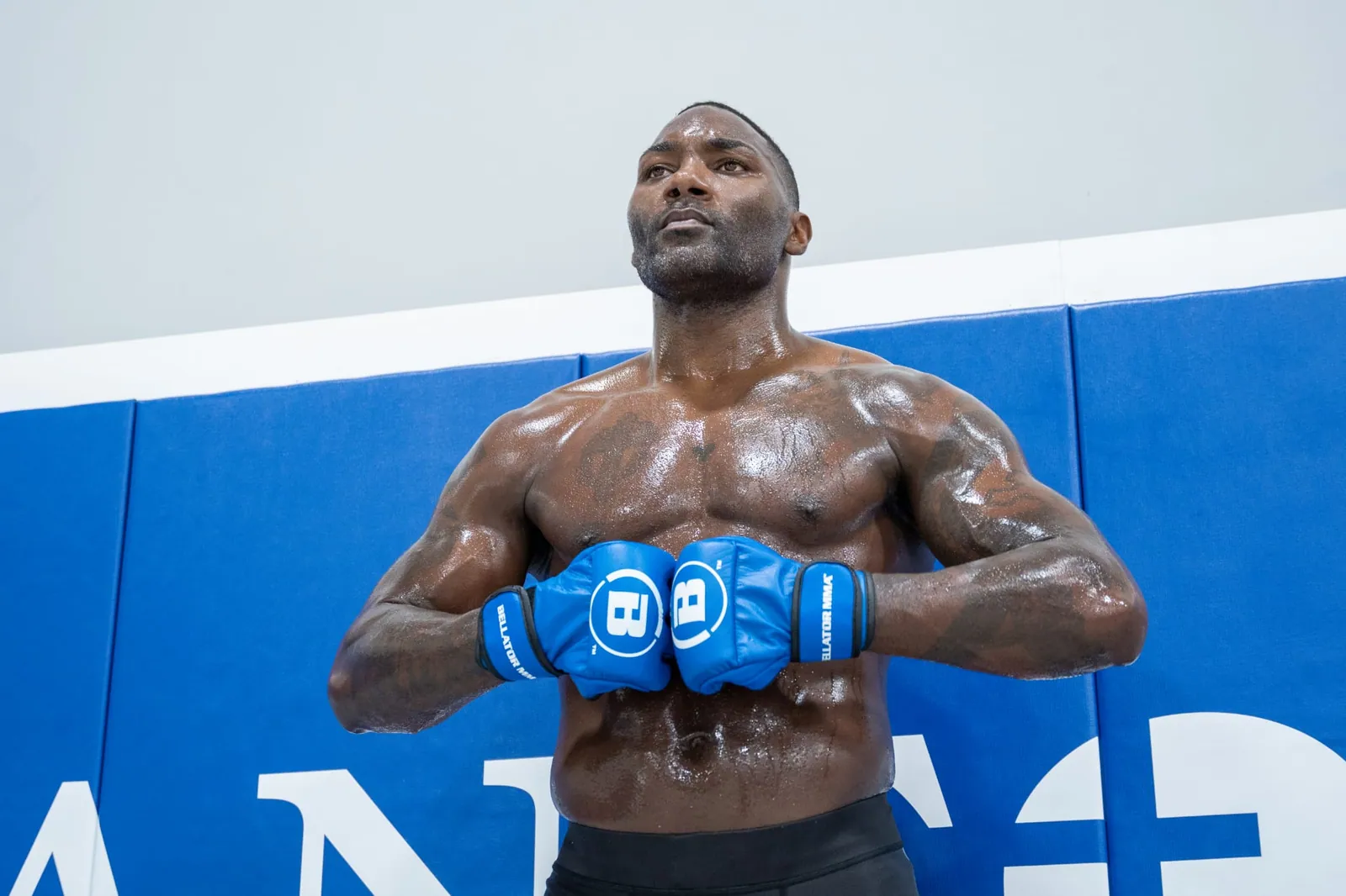 Anthony Johnson looking off camera between rounds of a training session.